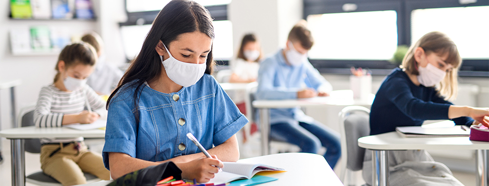 Student in classroom with mask