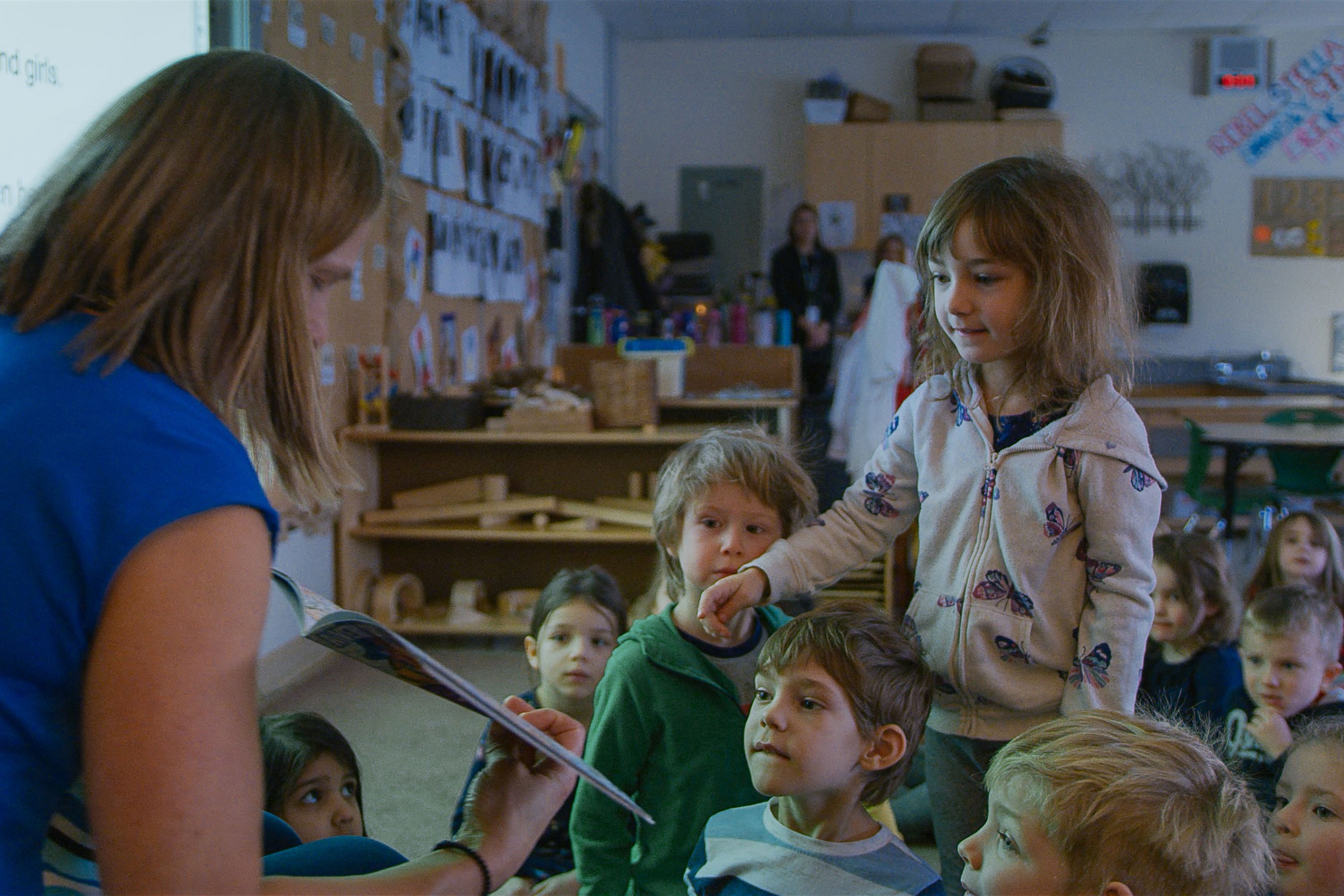 Kindergarten teacher reading to children